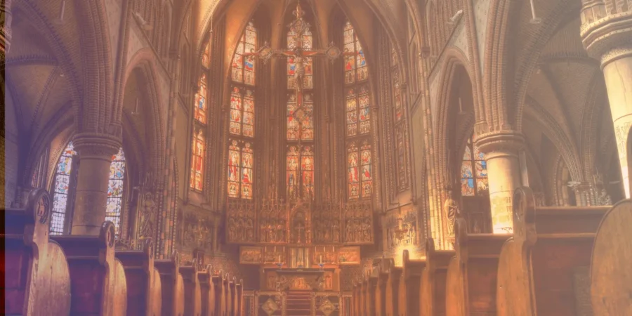 Interior of a grand cathedral with stained glass windows and ornate decorations.